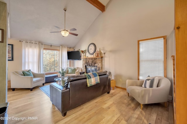 480 Spruce Dr, Tannersville, PA 18372 - living room with high vaulted ceiling, ceiling fan, light wood-type flooring, a stone fireplace, and beamed ceiling