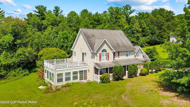 2247 Reo Dr, Effort, PA 18330 - rear view of house with a balcony, a lawn, and a forest view