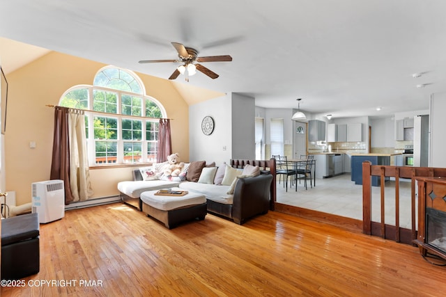 2247 Reo Dr, Effort, PA 18330 - living room featuring light wood finished floors, a ceiling fan, lofted ceiling, and a baseboard heating unit