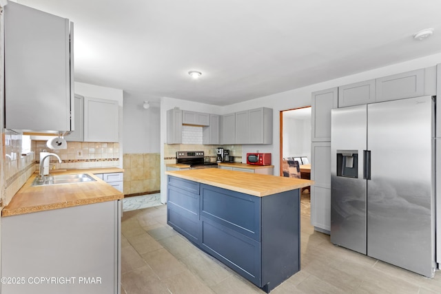 2247 Reo Dr, Effort, PA 18330 - kitchen featuring butcher block countertops, stainless steel appliances, decorative backsplash, a kitchen island, and gray cabinetry