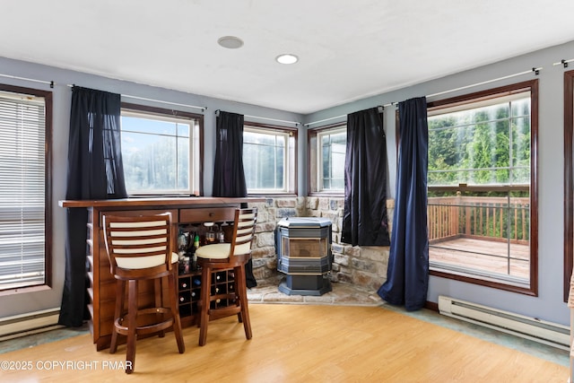 2247 Reo Dr, Effort, PA 18330 - dining area featuring baseboard heating, wood finished floors, a wood stove, and recessed lighting