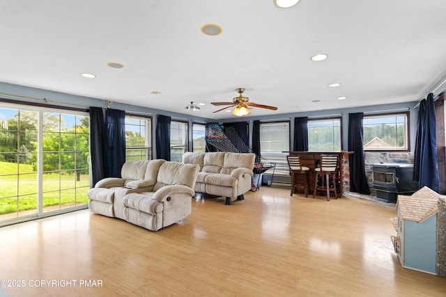 2247 Reo Dr, Effort, PA 18330 - living area featuring a wood stove, light wood-style floors, a ceiling fan, and recessed lighting