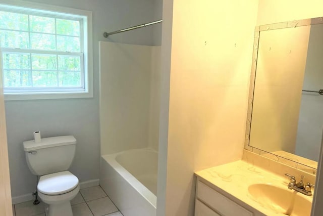 bathroom with baseboards, toilet, vanity, and tile patterned flooring