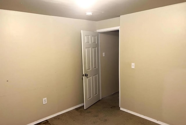 spare room with baseboards and concrete floors