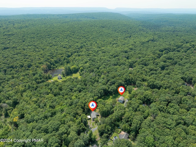 birds eye view of property with a wooded view