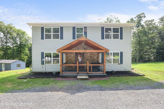 view of front of property featuring covered porch and a front yard