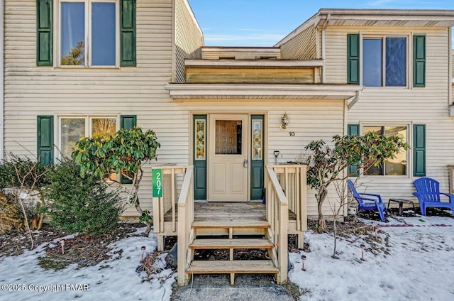 view of snow covered property entrance