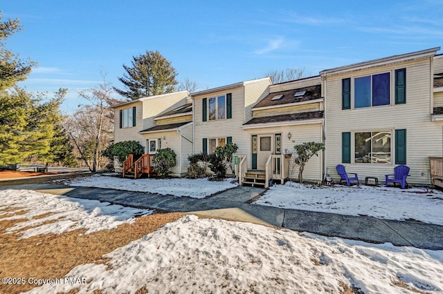 view of snow covered back of property