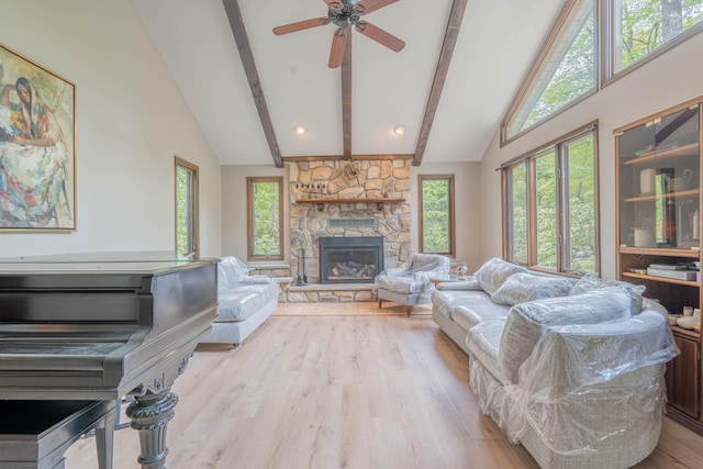 65 Maplewood Rd, Lake Harmony, PA 18624 - living room with beamed ceiling, plenty of natural light, a fireplace, wood finished floors, and high vaulted ceiling
