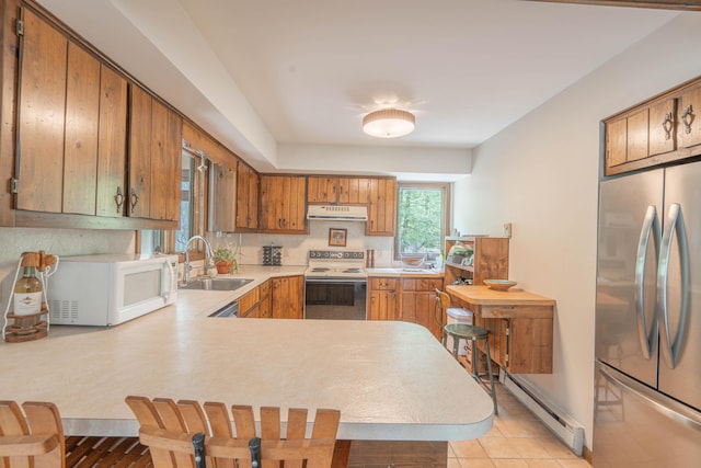 65 Maplewood Rd, Lake Harmony, PA 18624 - kitchen with white appliances, a sink, under cabinet range hood, baseboard heating, and light countertops