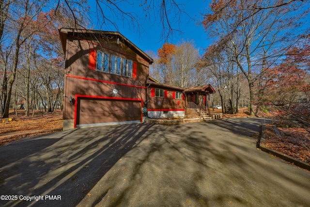 view of side of property featuring a garage and a porch