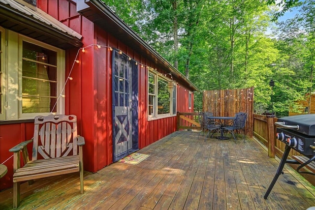 wooden deck featuring outdoor dining area and area for grilling