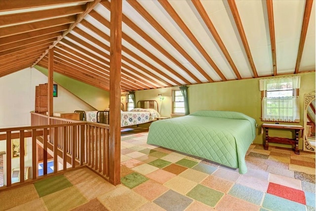 bedroom featuring multiple windows and lofted ceiling with beams