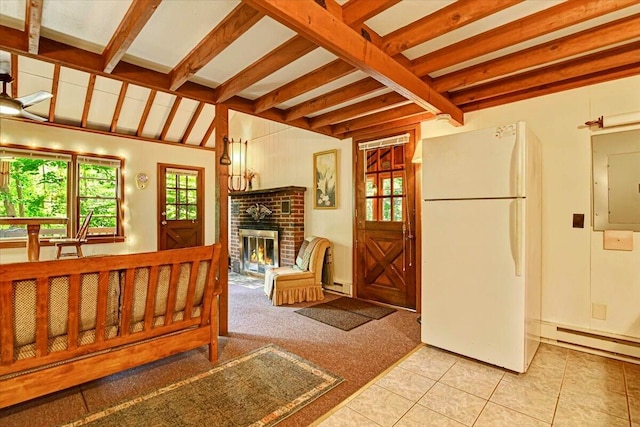 interior space with beamed ceiling, a baseboard radiator, electric panel, and a fireplace
