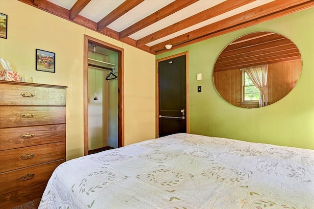 bedroom featuring a closet and beam ceiling