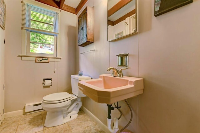 bathroom with toilet, a baseboard heating unit, baseboards, and tile patterned flooring