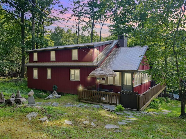 back of property with a chimney