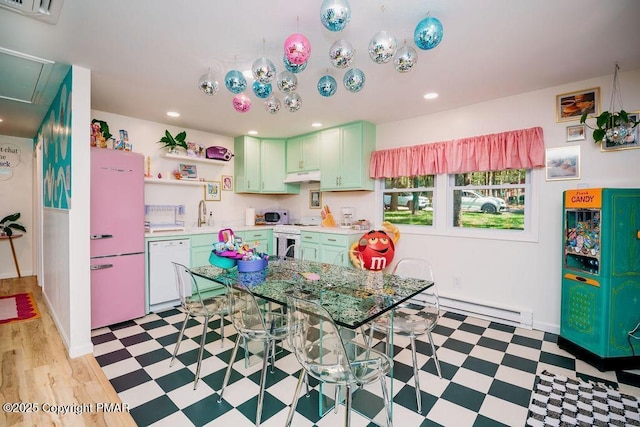 kitchen featuring green cabinetry, light floors, light countertops, white appliances, and open shelves