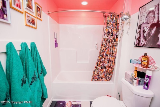 bathroom featuring toilet and shower / bath combination with curtain