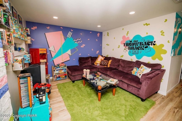 living room with recessed lighting, baseboards, and wood finished floors