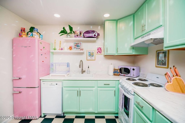 kitchen with tile patterned floors, under cabinet range hood, a sink, white appliances, and light countertops