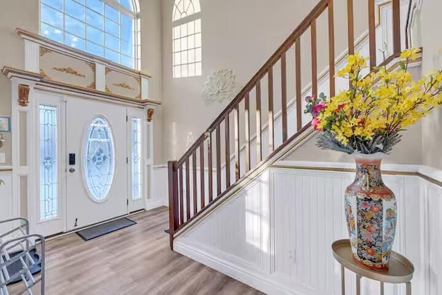 7075 Boulder Ct, Tobyhanna, PA 18466 - foyer with a high ceiling, stairs, and wood finished floors