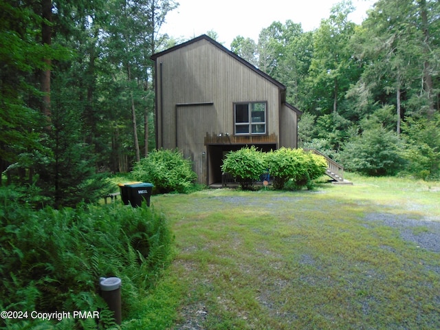 exterior space with an outdoor structure, stairway, and a garage