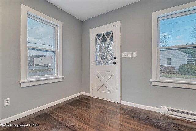 entrance foyer featuring baseboards, baseboard heating, and a healthy amount of sunlight