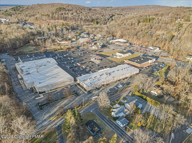 drone / aerial view featuring a view of trees