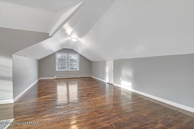 bonus room with lofted ceiling, baseboards, a baseboard heating unit, and wood finished floors