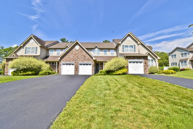 1785 Big Ridge Dr, East Stroudsburg, PA 18302 - townhome / multi-family property featuring asphalt driveway, stone siding, and a front yard