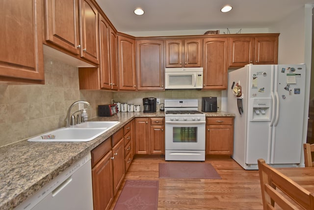 1785 Big Ridge Dr, East Stroudsburg, PA 18302 - kitchen with white appliances, light wood-style floors, backsplash, brown cabinetry, and recessed lighting