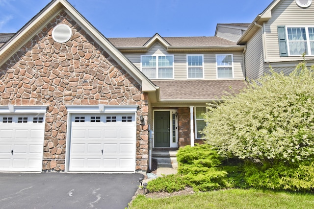 1785 Big Ridge Dr, East Stroudsburg, PA 18302 - view of front of house with stone siding, asphalt driveway, and an attached garage