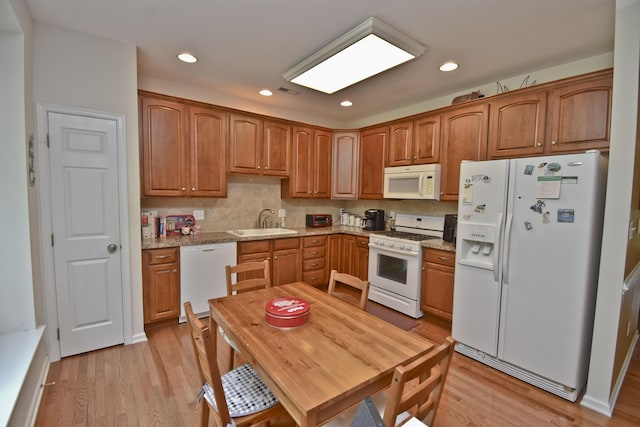 1785 Big Ridge Dr, East Stroudsburg, PA 18302 - kitchen with white appliances, light wood finished floors, recessed lighting, light stone countertops, and brown cabinetry