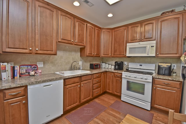 1785 Big Ridge Dr, East Stroudsburg, PA 18302 - kitchen featuring white appliances, light wood finished floors, tasteful backsplash, recessed lighting, and brown cabinets