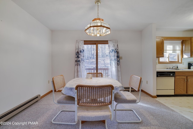 dining space featuring a chandelier, a baseboard radiator, light carpet, and baseboards