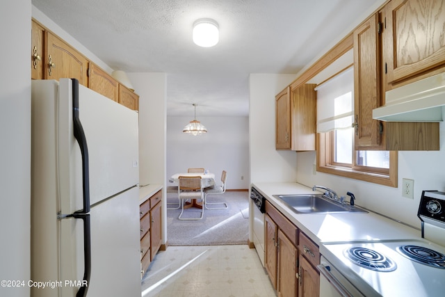 kitchen featuring white appliances, light floors, light countertops, under cabinet range hood, and a sink