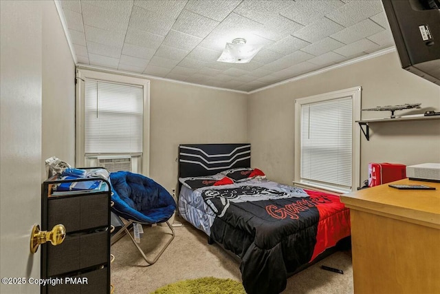 bedroom with carpet floors, ornamental molding, and cooling unit