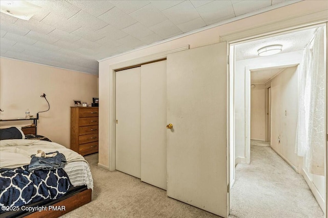 bedroom with a closet and light colored carpet