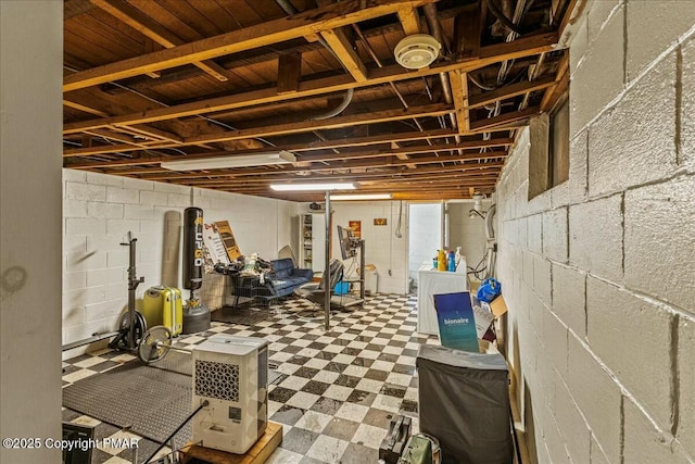 unfinished below grade area with washer / dryer and tile patterned floors