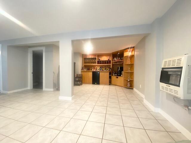 1293 Winding Way, Tobyhanna, PA 18466 - unfurnished living room featuring heating unit, a bar, and light tile patterned flooring