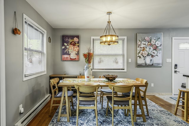268 Outer Dr, Pocono Lake, PA 18347 - dining space featuring a baseboard heating unit, wood finished floors, a chandelier, and baseboards