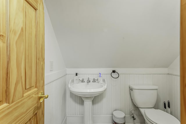 268 Outer Dr, Pocono Lake, PA 18347 - half bathroom featuring toilet, a wainscoted wall, vaulted ceiling, and a sink