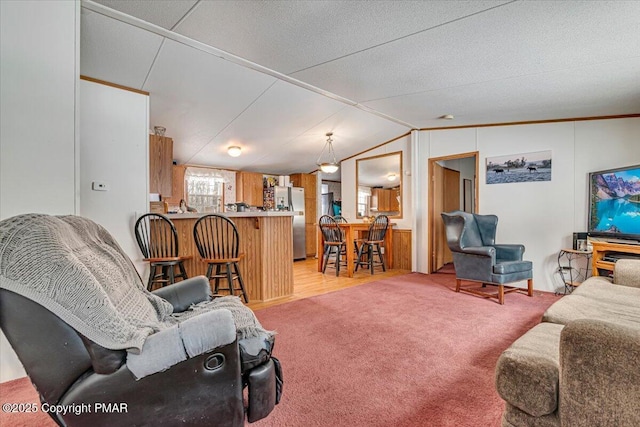 living room with light carpet and vaulted ceiling