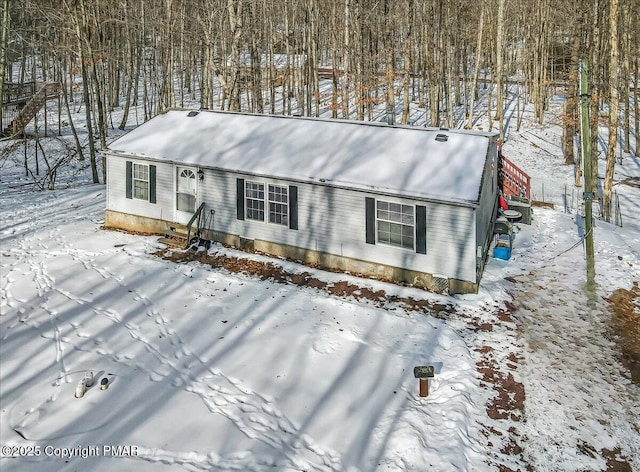 snow covered property featuring entry steps