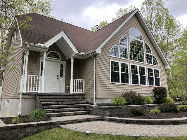 view of front facade with roof with shingles