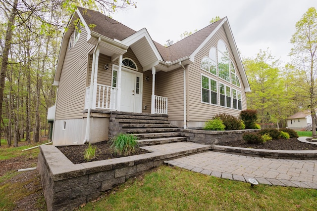 view of front of home with a shingled roof
