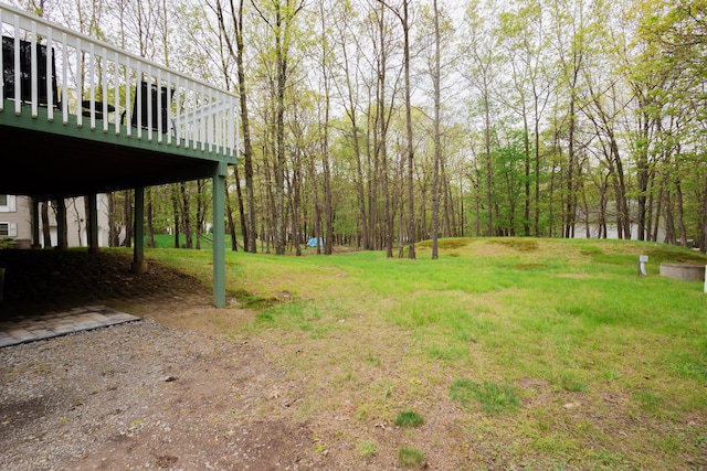 view of grassy yard with a deck