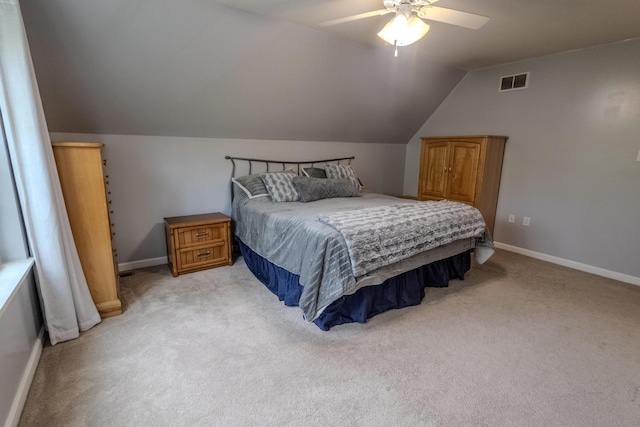 bedroom featuring light colored carpet, lofted ceiling, a ceiling fan, and baseboards