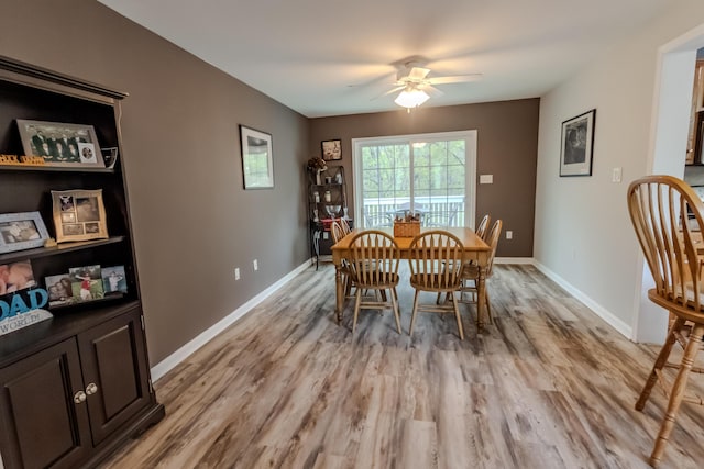 dining space featuring light wood-type flooring, ceiling fan, and baseboards